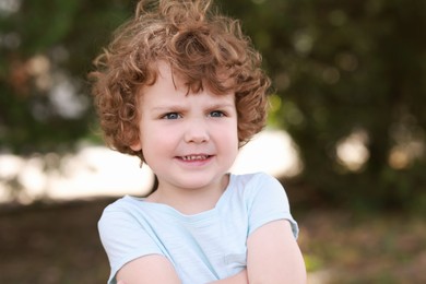 Photo of Portrait of little boy outdoors. Cute child