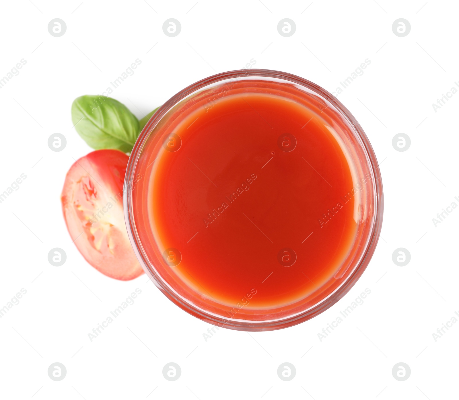 Photo of Tasty tomato juice in glass, basil and fresh vegetable isolated on white, top view