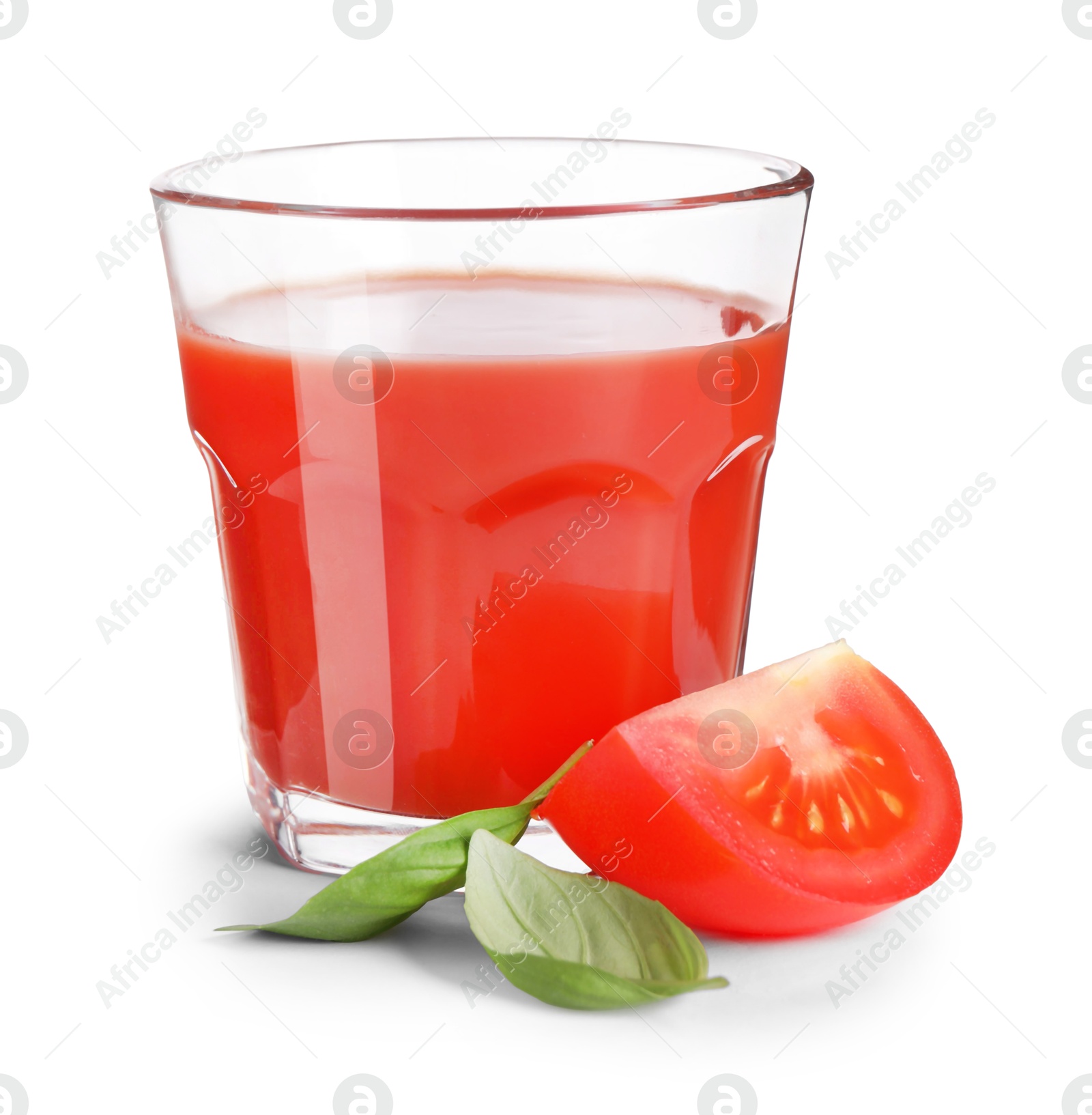 Photo of Tasty tomato juice in glass, basil and fresh vegetable isolated on white