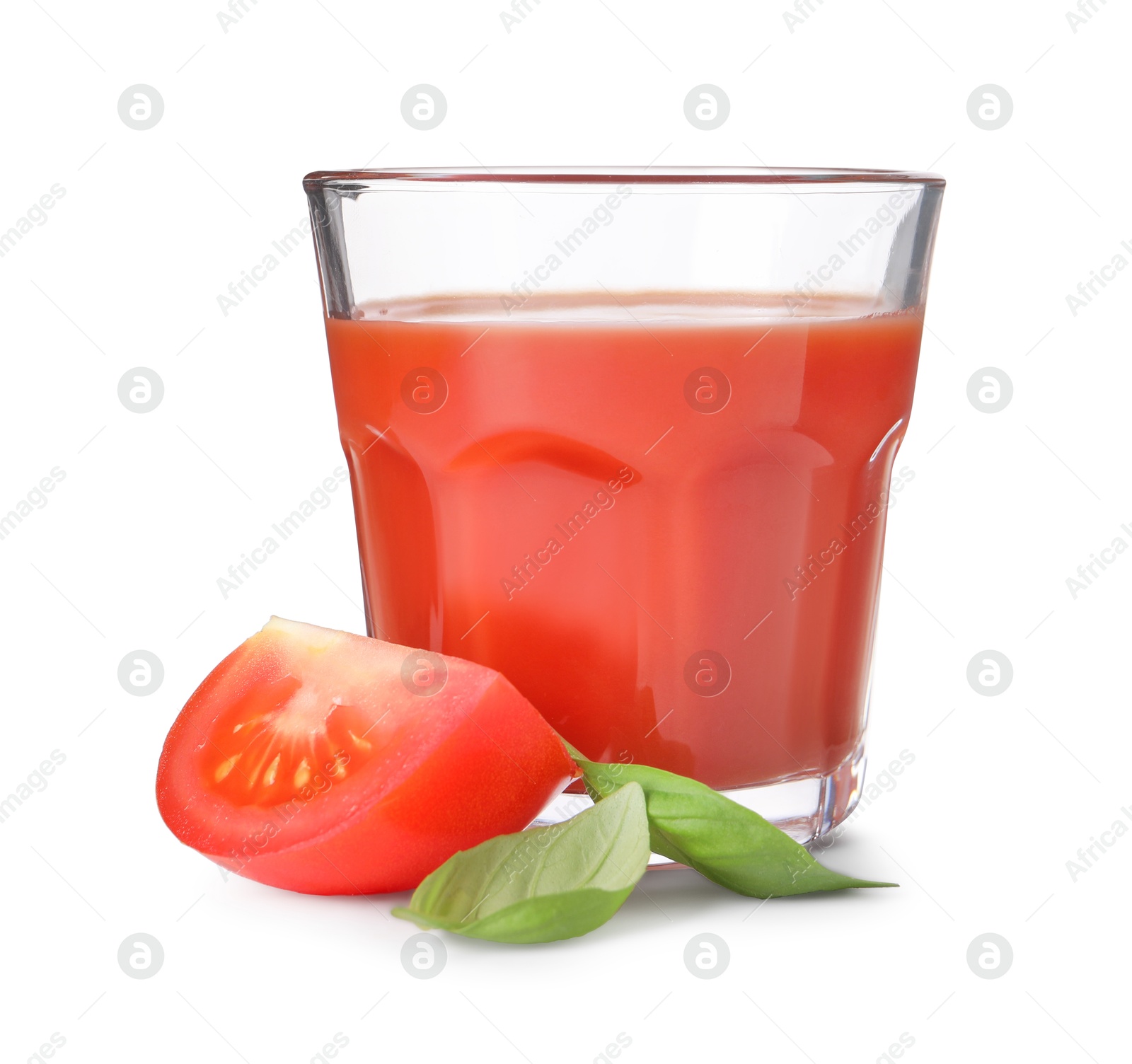 Photo of Tasty tomato juice in glass, basil and fresh vegetable isolated on white