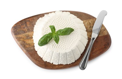 Photo of Tasty ricotta (cream cheese), basil and knife isolated on white, top view