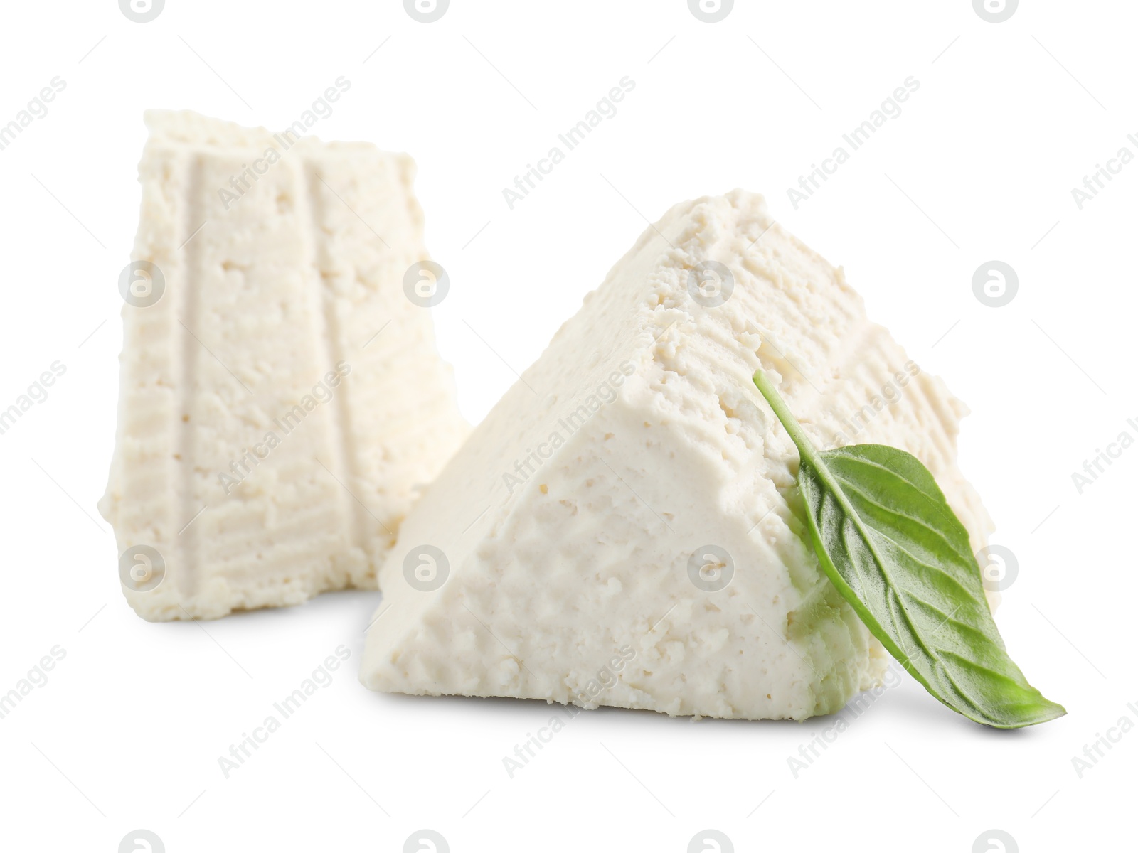 Photo of Tasty ricotta (cream cheese) and basil isolated on white