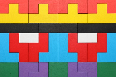 Photo of Colorful wooden puzzle pieces as background, top view