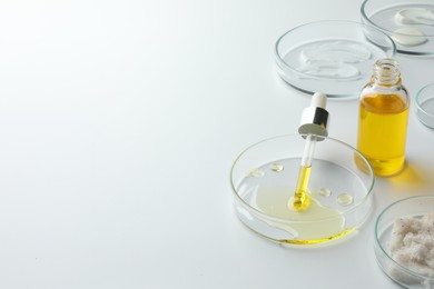 Petri dishes with different cosmetic products on white background. Space for text