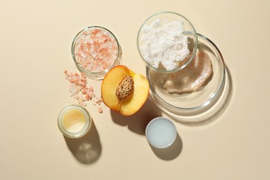 Photo of Petri dishes with different cosmetic products and peach on beige background, flat lay