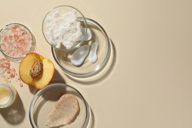 Photo of Petri dishes with different cosmetic products and peach on beige background, flat lay. Space for text