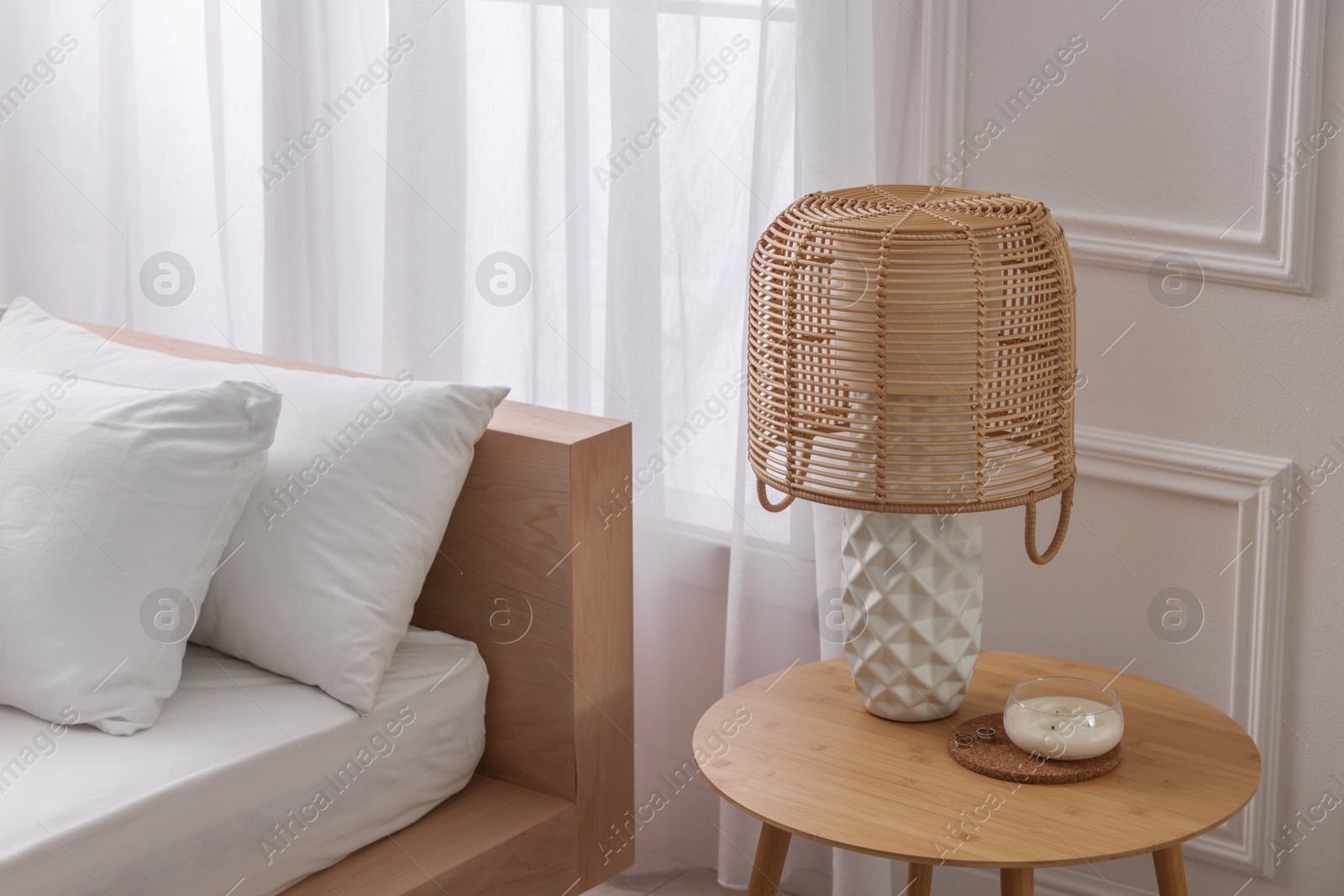 Photo of Stylish living room interior with bed, bedside table and lamp