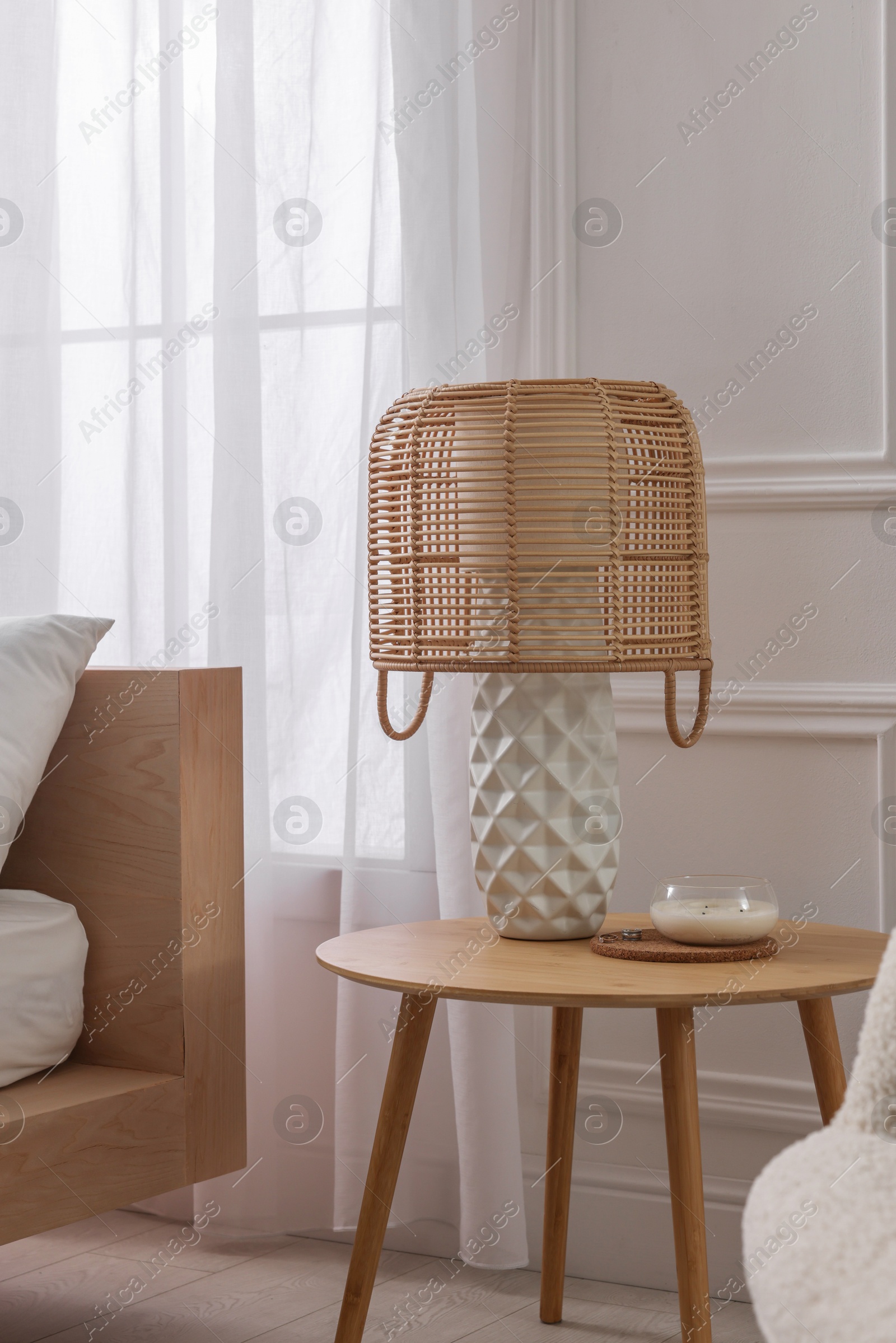 Photo of Stylish living room interior with bed, bedside table and lamp