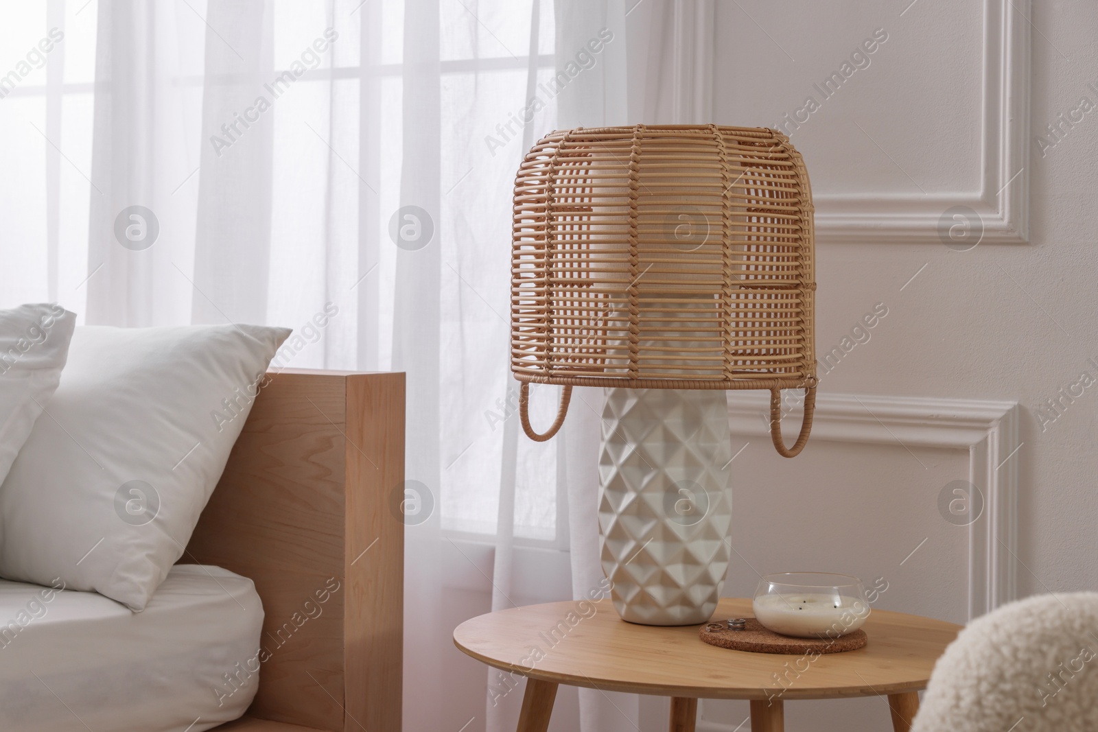 Photo of Stylish living room interior with bed, bedside table and lamp