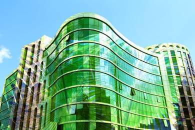 Image of Environment. Modern building and green palm leaves, double exposure