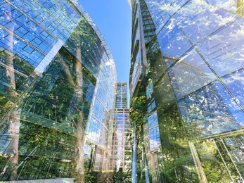 Image of Environment. Modern buildings and trees, double exposure