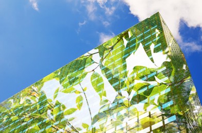 Environment. Modern building and tree branch, double exposure