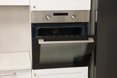 Photo of Open electric oven in kitchen. Cooking appliance