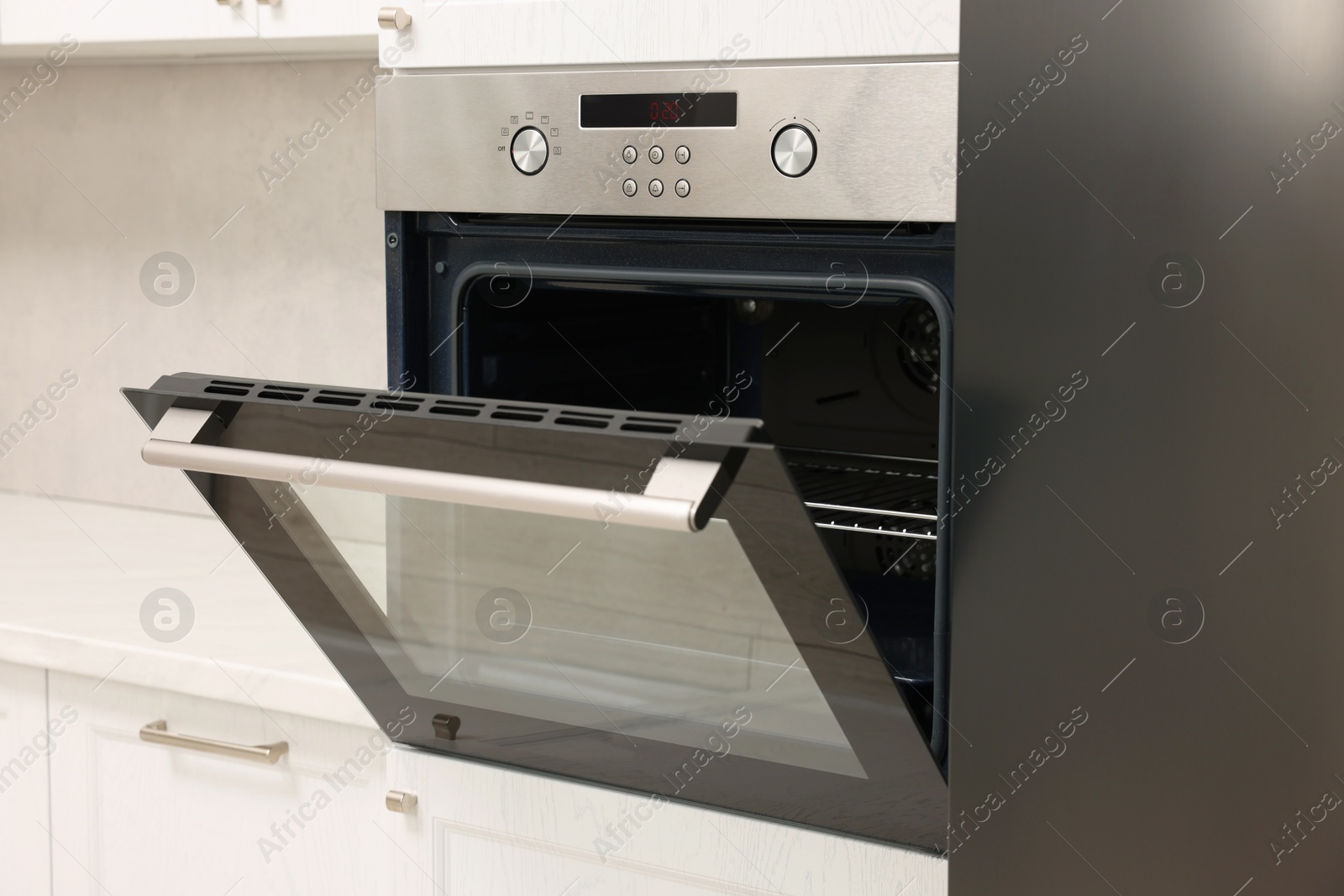 Photo of Open electric oven in kitchen. Cooking appliance