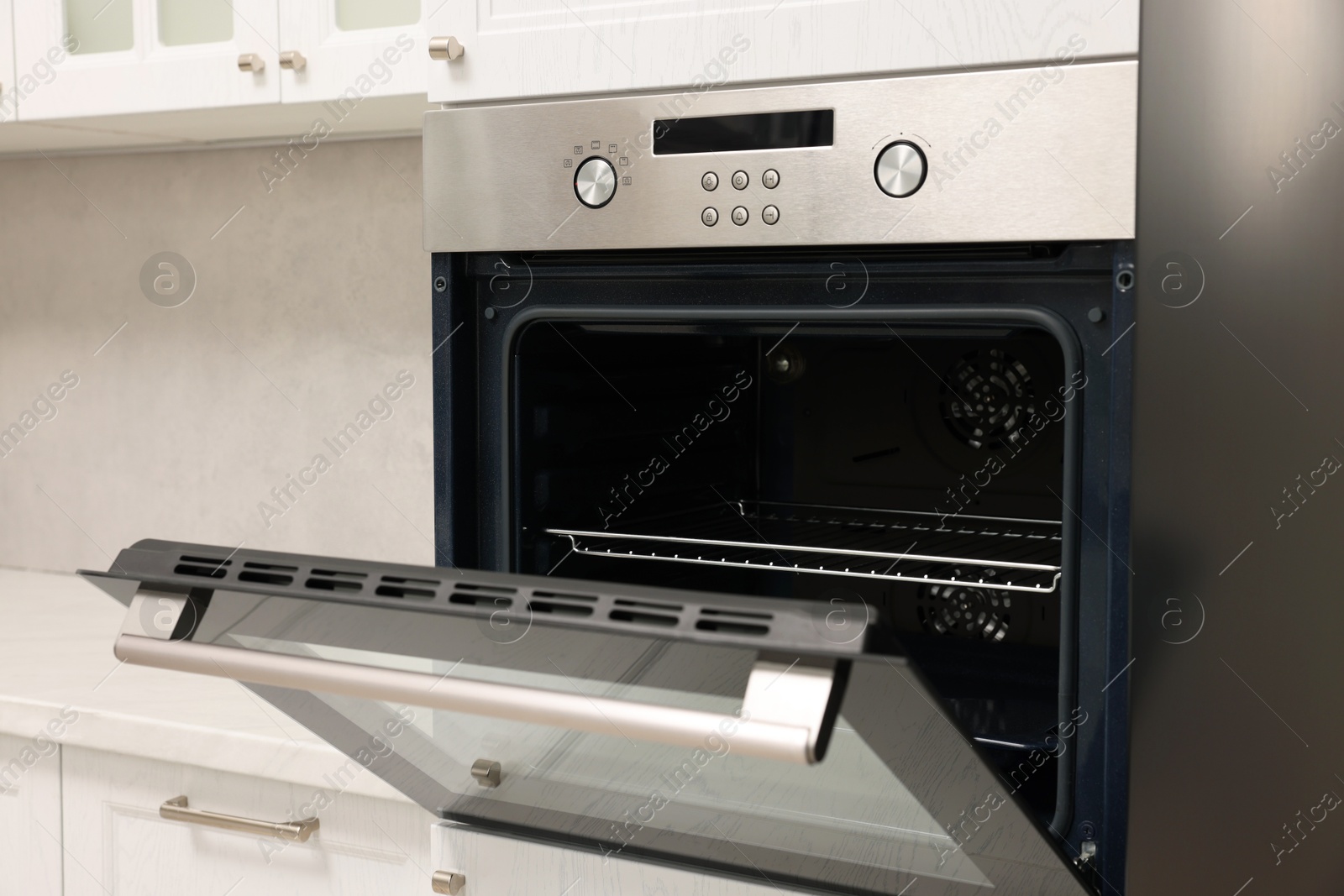 Photo of Open electric oven in kitchen. Cooking appliance