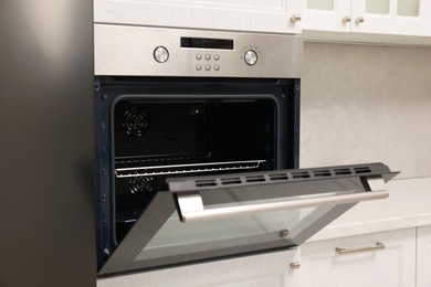 Open electric oven in kitchen. Cooking appliance