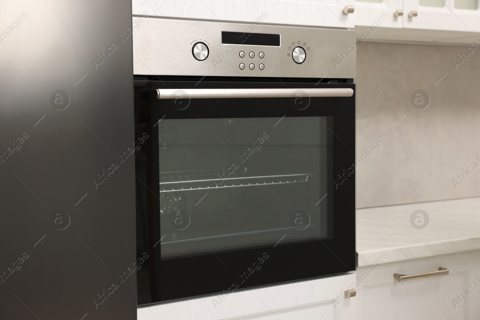 Photo of New electric oven in kitchen. Cooking appliance