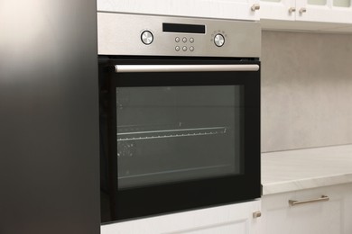 Photo of New electric oven in kitchen. Cooking appliance