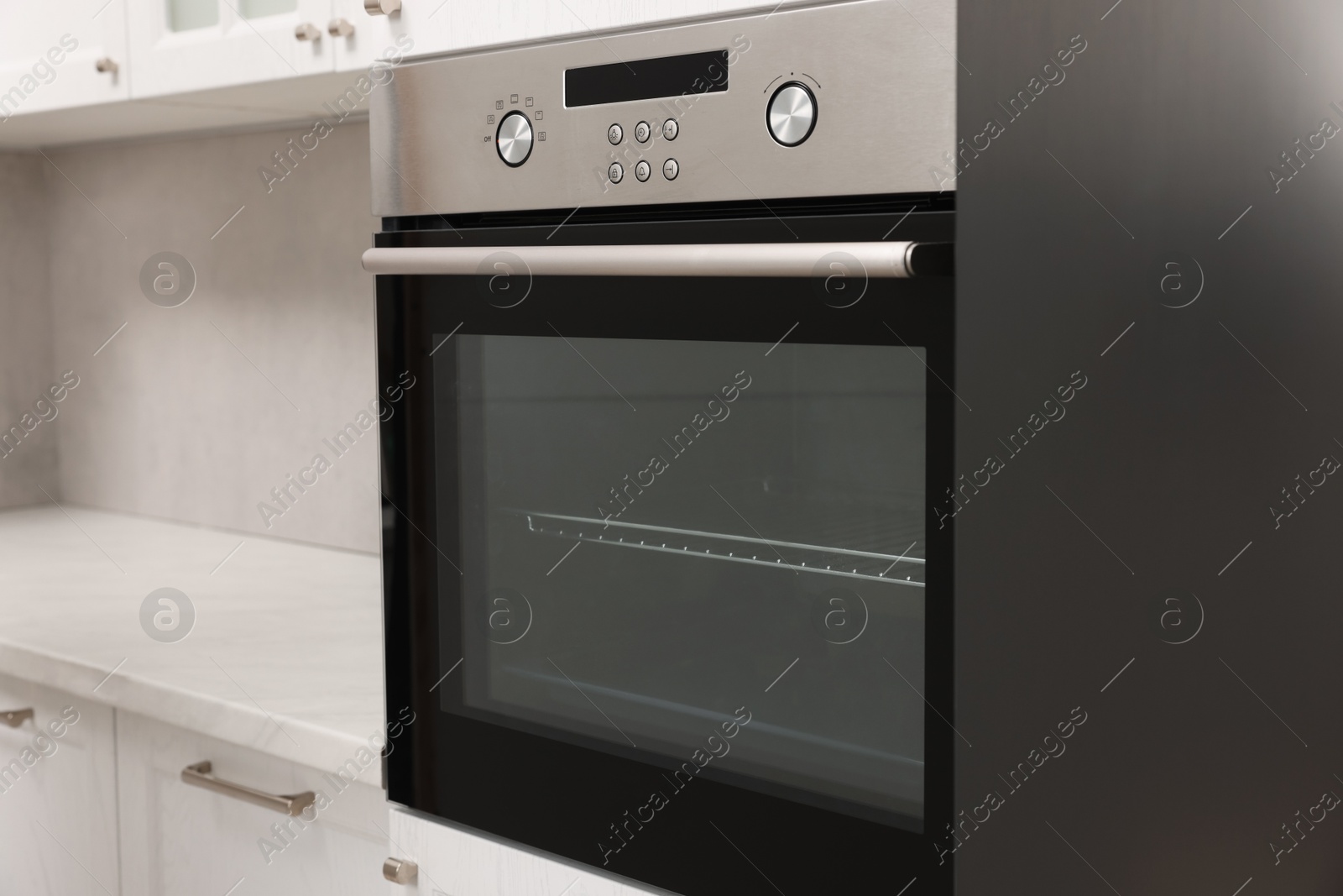 Photo of New electric oven in kitchen. Cooking appliance