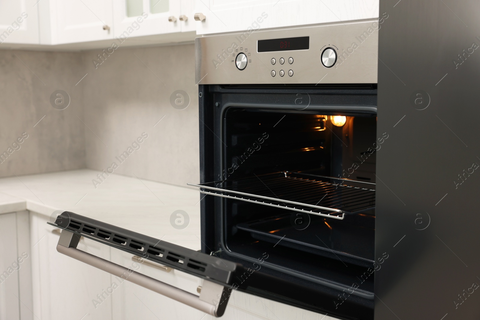 Photo of Open electric oven in kitchen. Cooking appliance