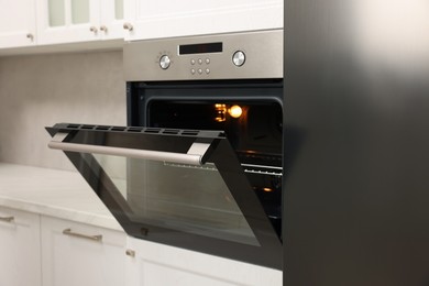 Open electric oven in kitchen. Cooking appliance