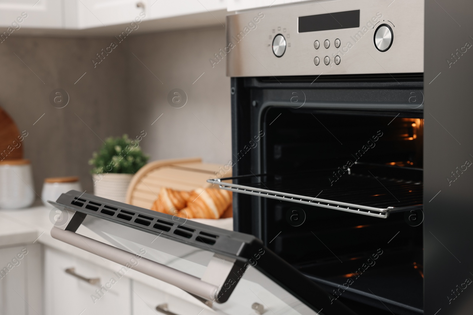 Photo of Open electric oven in kitchen. Cooking appliance