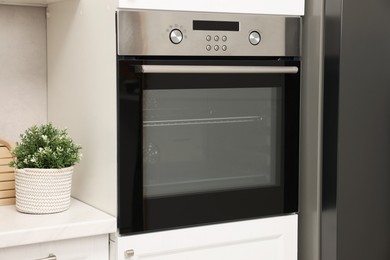 Photo of New electric oven in kitchen. Cooking appliance