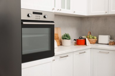 Photo of New electric oven in kitchen. Cooking appliance