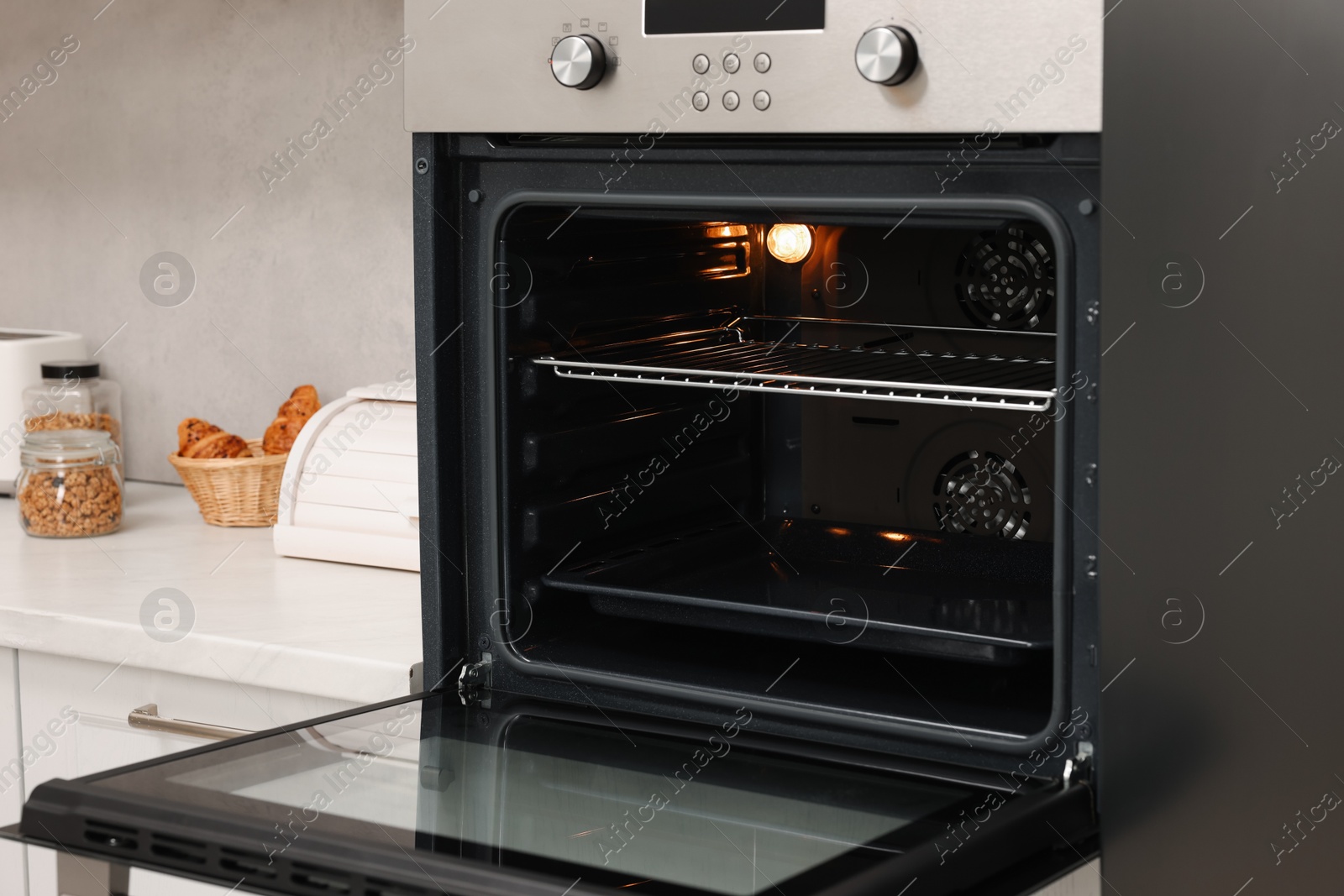 Photo of Open electric oven in kitchen. Cooking appliance