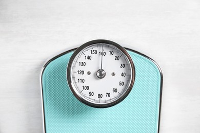 Photo of One bathroom scale on white wooden background, top view