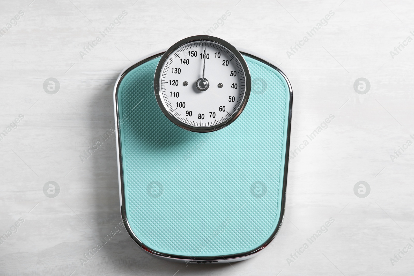 Photo of One bathroom scale on white wooden background, top view