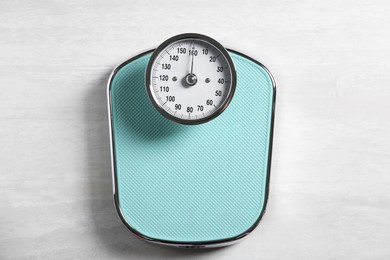 Photo of One bathroom scale on white wooden background, top view