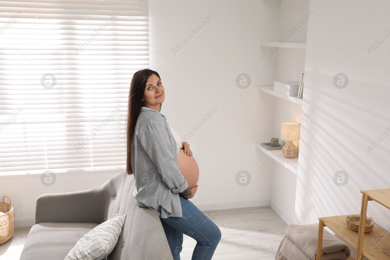 Photo of Portrait of beautiful pregnant woman at home