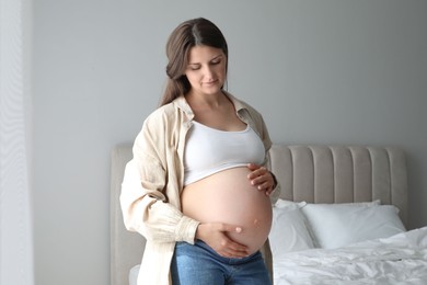 Portrait of beautiful pregnant woman at home