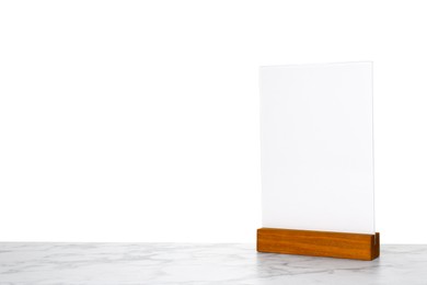 Photo of Menu holder on light marble table against white background. Space for text