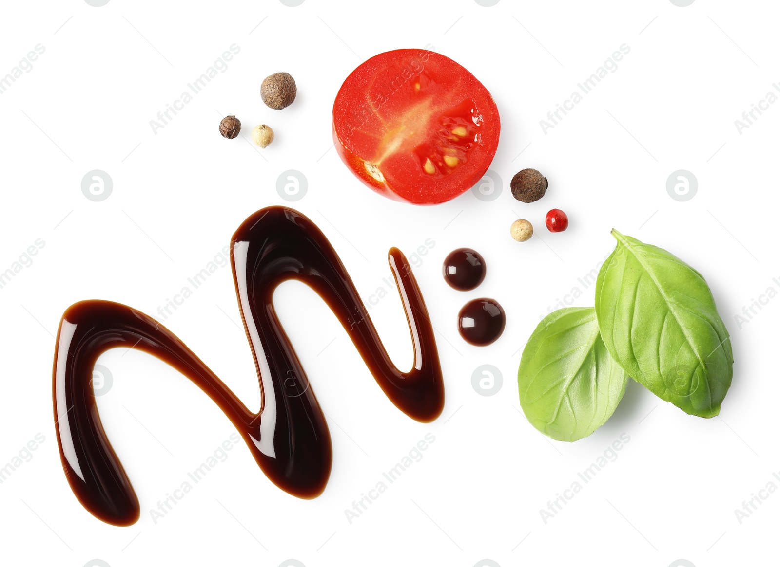 Photo of Delicious balsamic vinegar, cut tomato, basil and peppercorns isolated on white, top view