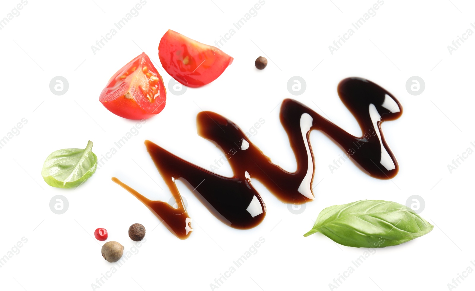 Photo of Delicious balsamic vinegar, cut tomato, basil and peppercorns isolated on white