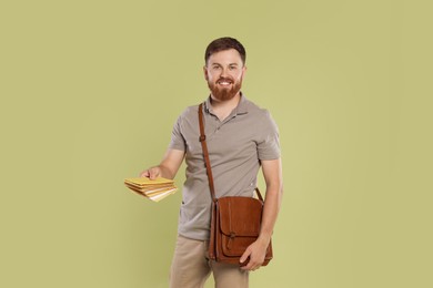 Photo of Postman with brown bag delivering letters on light green background