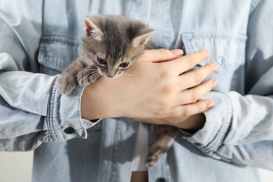 Photo of Woman with cute fluffy kitten, closeup view