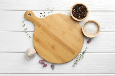 Photo of Cutting board and different spices on white wooden table, flat lay