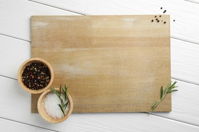 Photo of Cutting board and different spices on white wooden table, flat lay