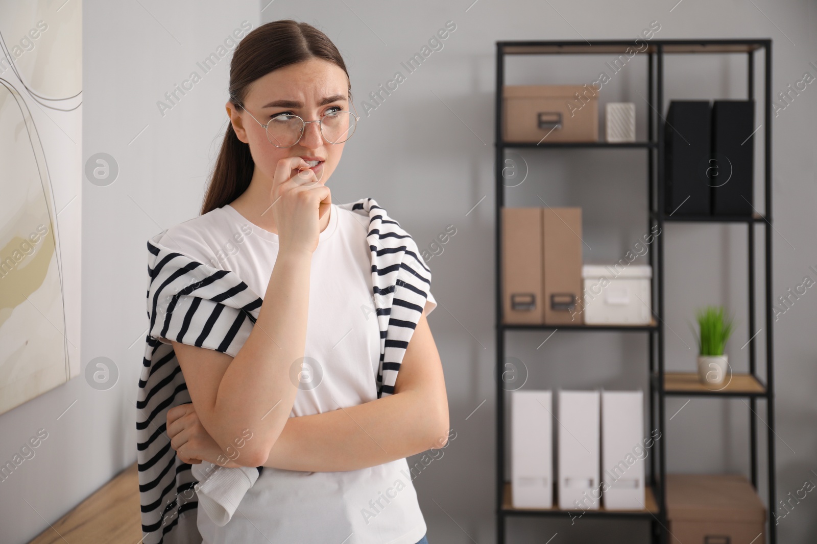 Photo of Portrait of embarrassed woman in glasses in office