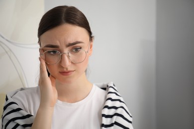 Photo of Portrait of embarrassed woman in glasses in office, space for text