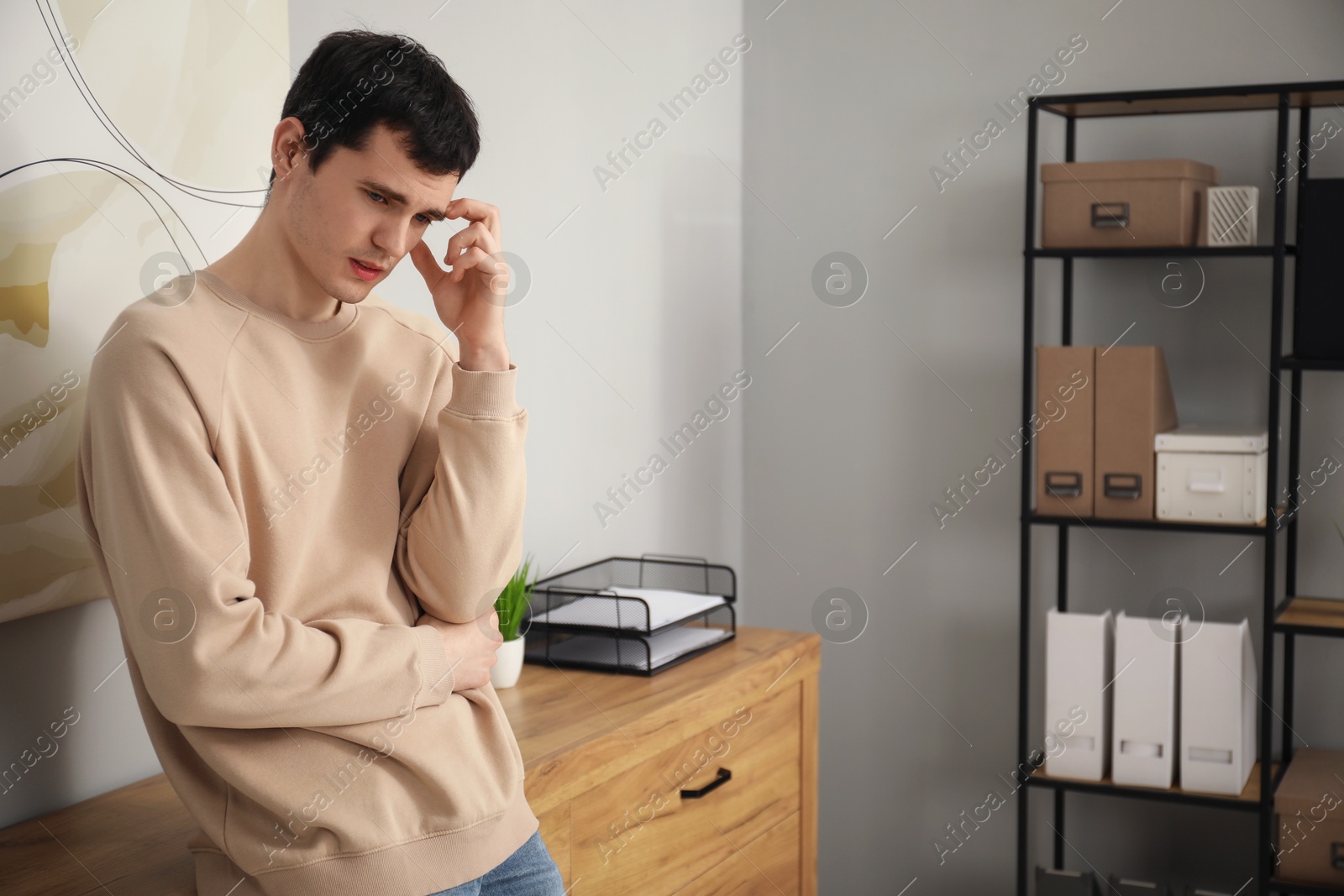 Photo of Portrait of embarrassed young man in office