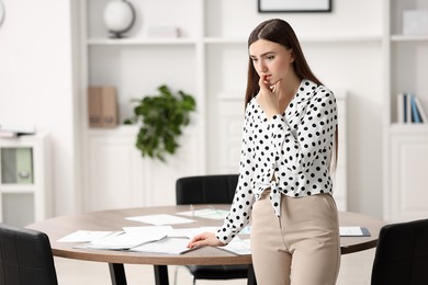 Photo of Embarrassed woman in office, space for text