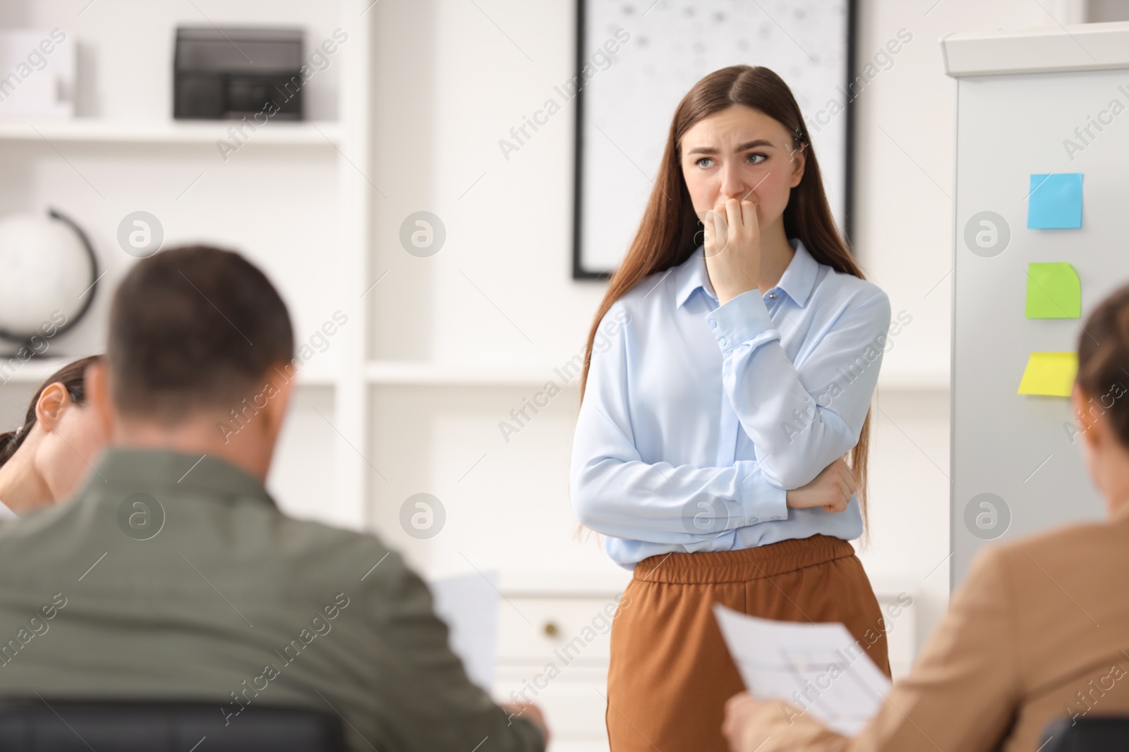 Photo of Woman feeling embarrassed during business meeting in office