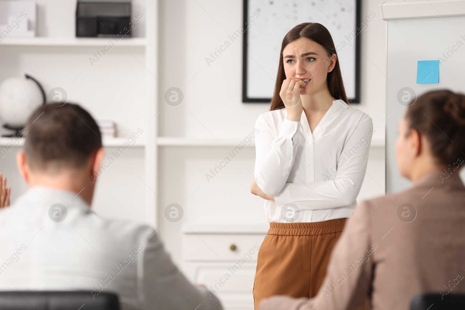 Photo of Woman feeling embarrassed during business meeting in office