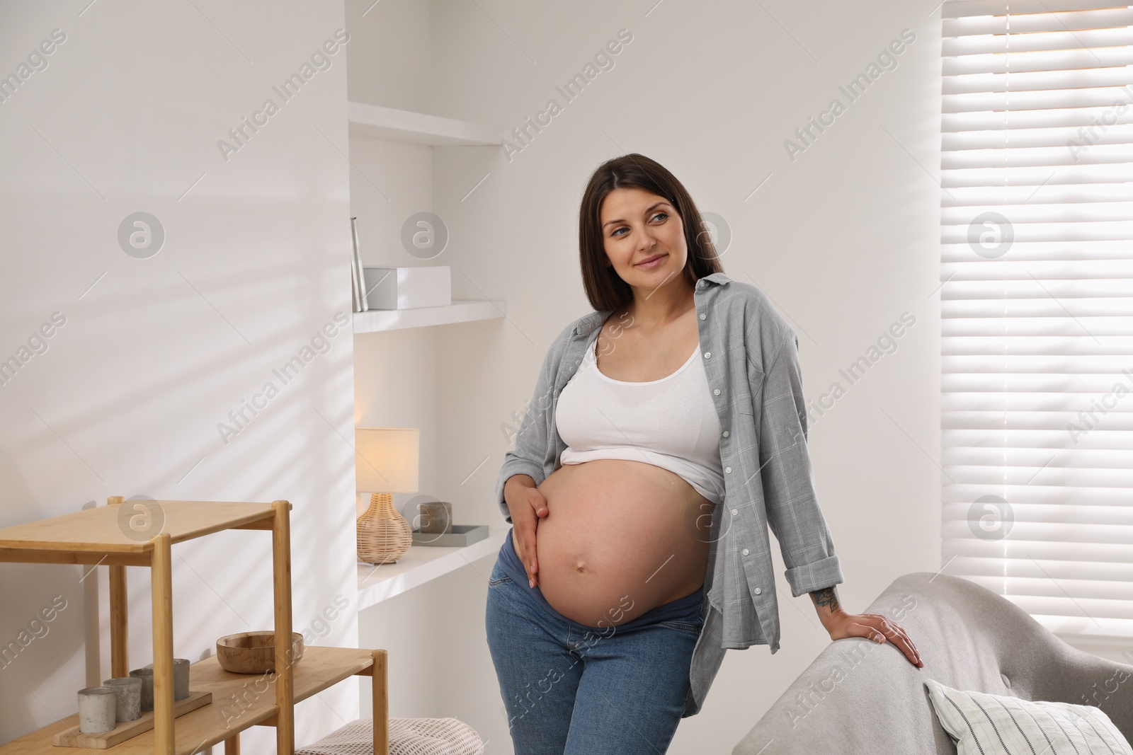 Photo of Portrait of beautiful pregnant woman at home