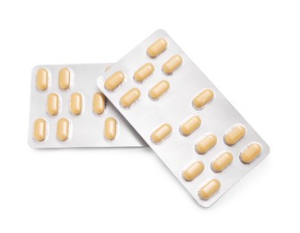 Photo of Antibiotic pills in blisters isolated on white, top view