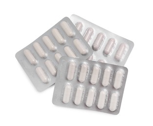 Photo of Antibiotic pills in blisters isolated on white, top view